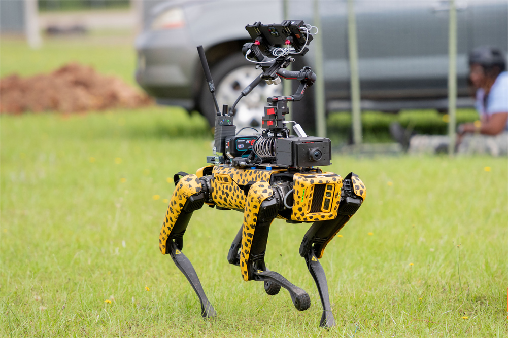 An uncrewed ground vehicle (UGV) prepares to assess injuries from simulated casualty.