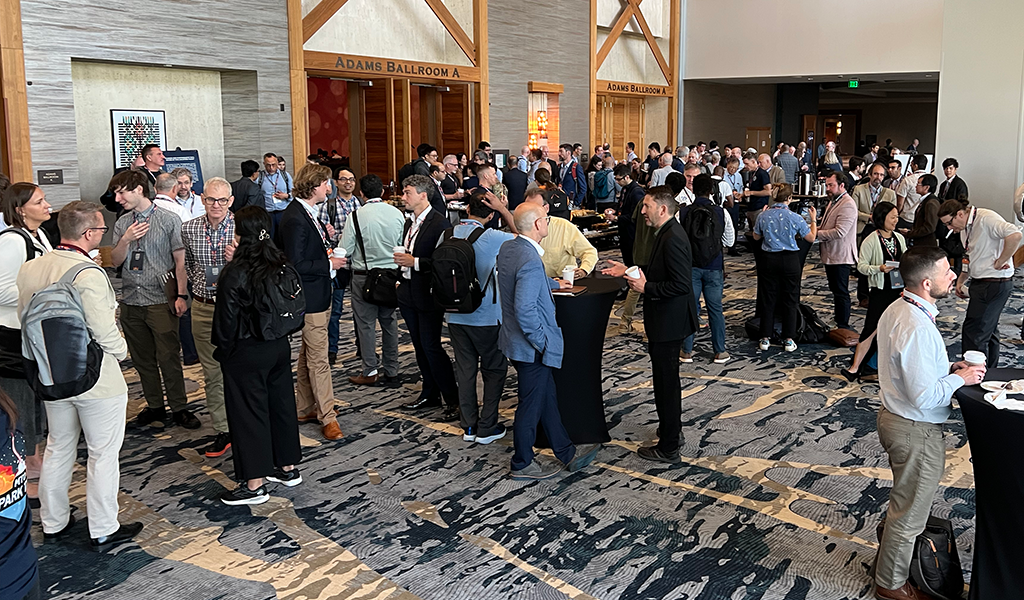 Spark Tank attendees, program managers, and staff during a networking break.