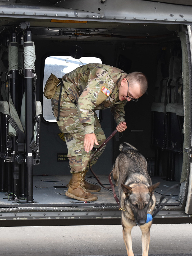 As part of the training orientation process, the dogs were led by their handlers to the flight line and practiced boarding and dismounting the helicopter while the rotors were spinning.