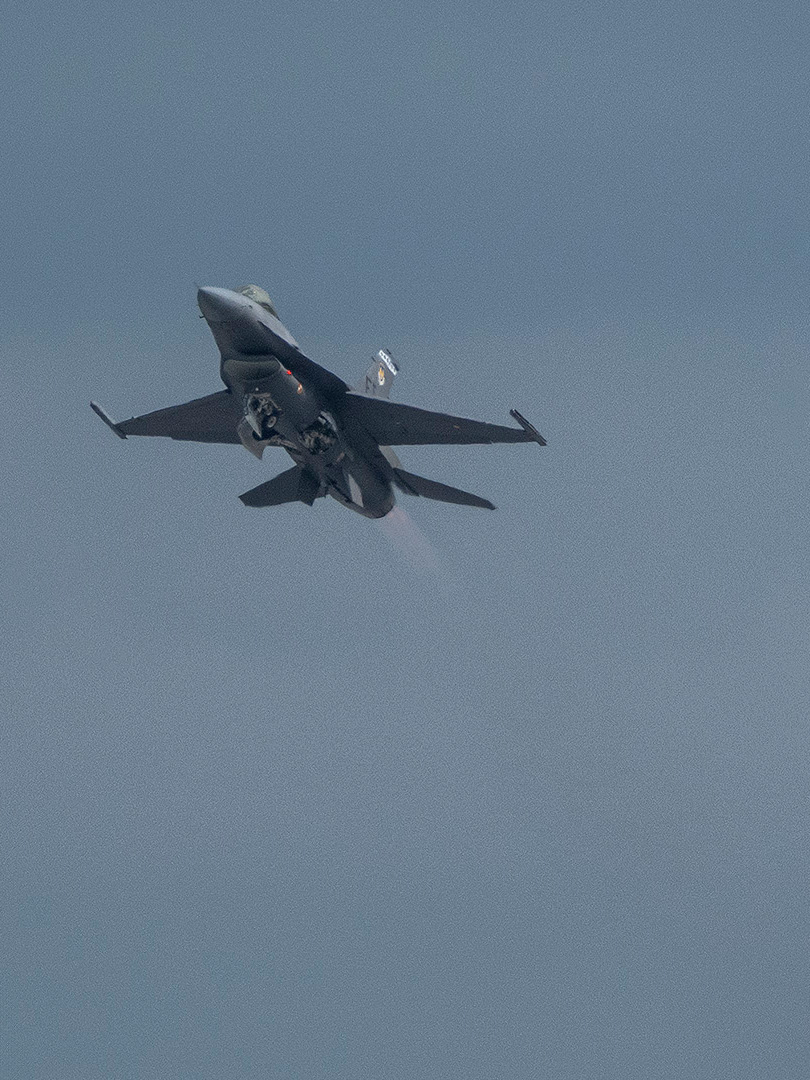 An F-16 modified with the Viper Experimentation and Next-generation Operations Model (VENOM) Autonomy Kit performs human-on-the-loop in-air testing of AI models, advancing flight autonomy within DARPA's Artificial Intelligence Reinforcements (AIR) program.